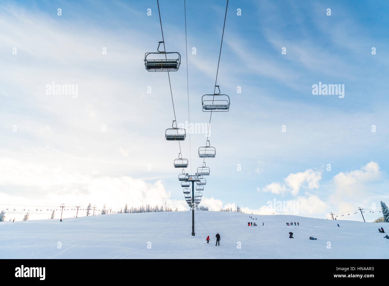 beautiful ski lift over snow mountain in ski resort with blue sky background. Stock Photo