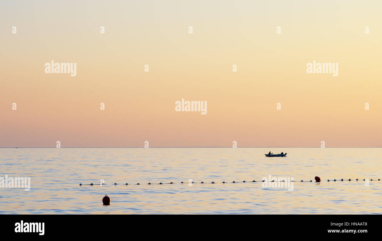 silhouette of fishermen boats fishing in sunset at the beach Stock ...
