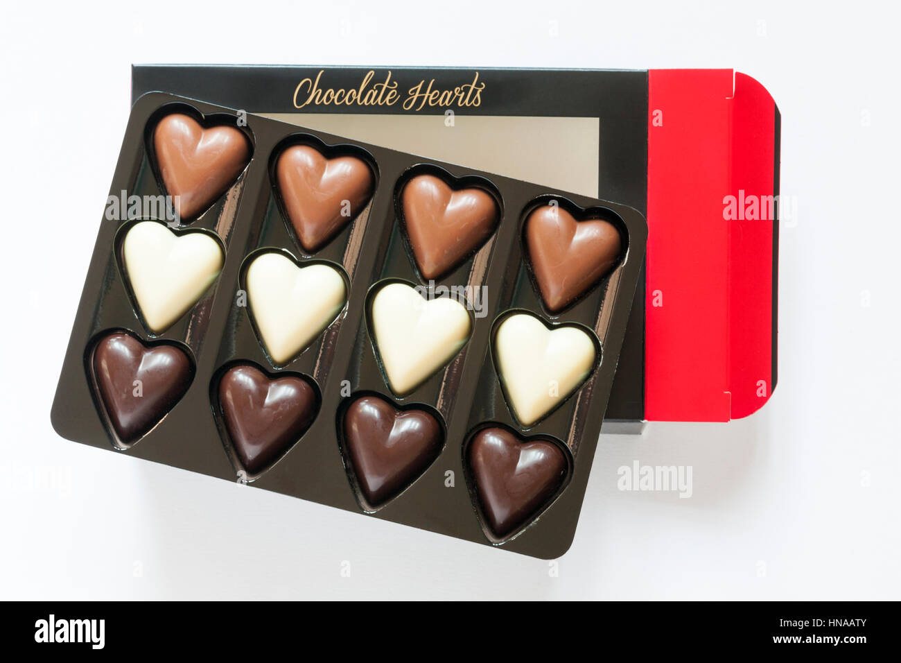 Chocolate Hearts chocolates in pack containing dark chocolate, milk chocolate and white chocolate hearts, with box isolated on white background Stock Photo
