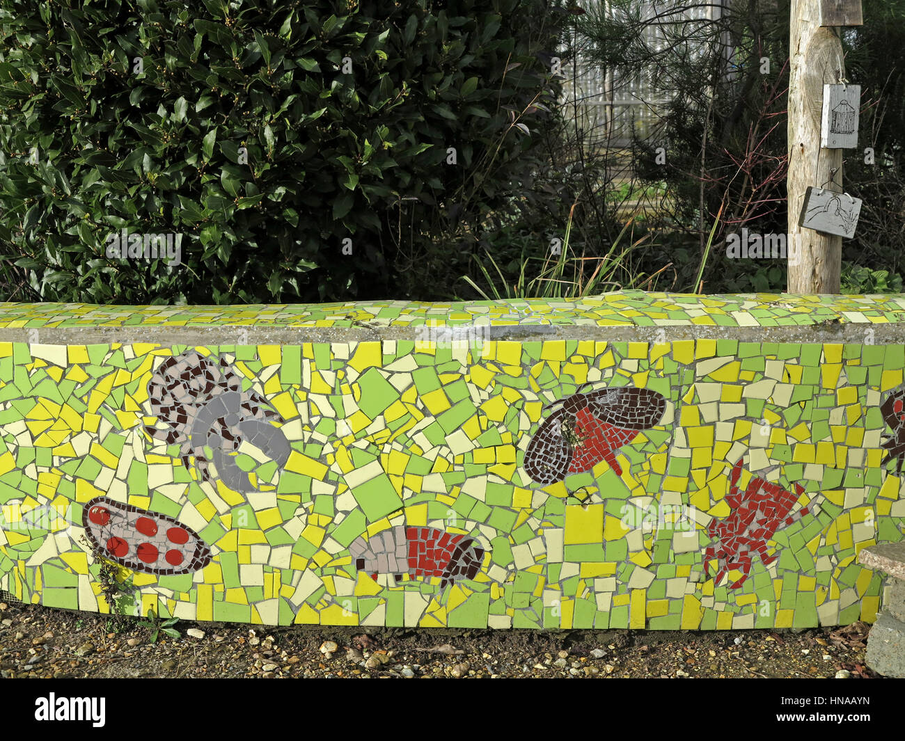 Green mosaic garden wall embellished with butterflies and dragonflies Stock Photo Alamy