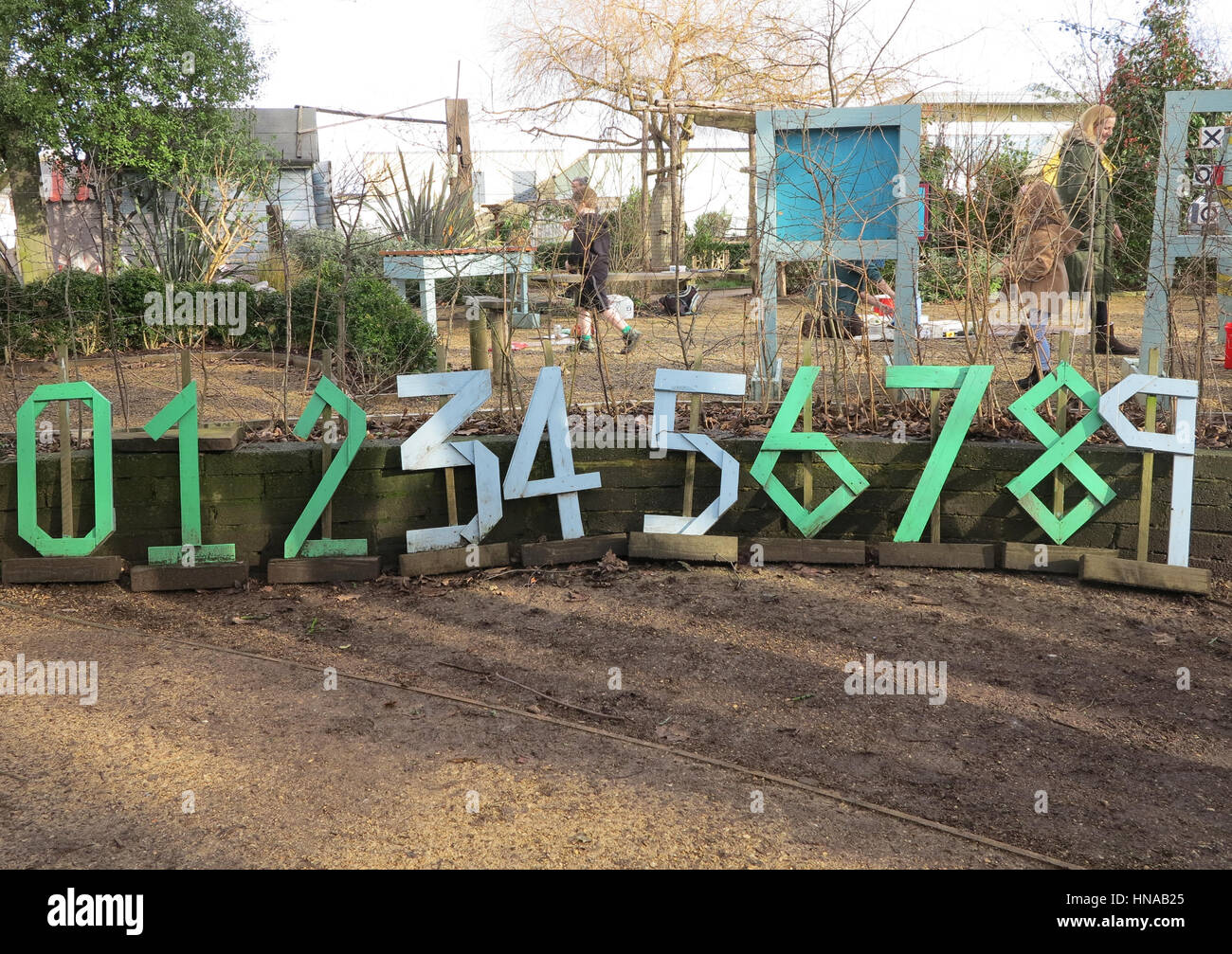 Large wooden numbers made by children at school gardening club Stock Photo