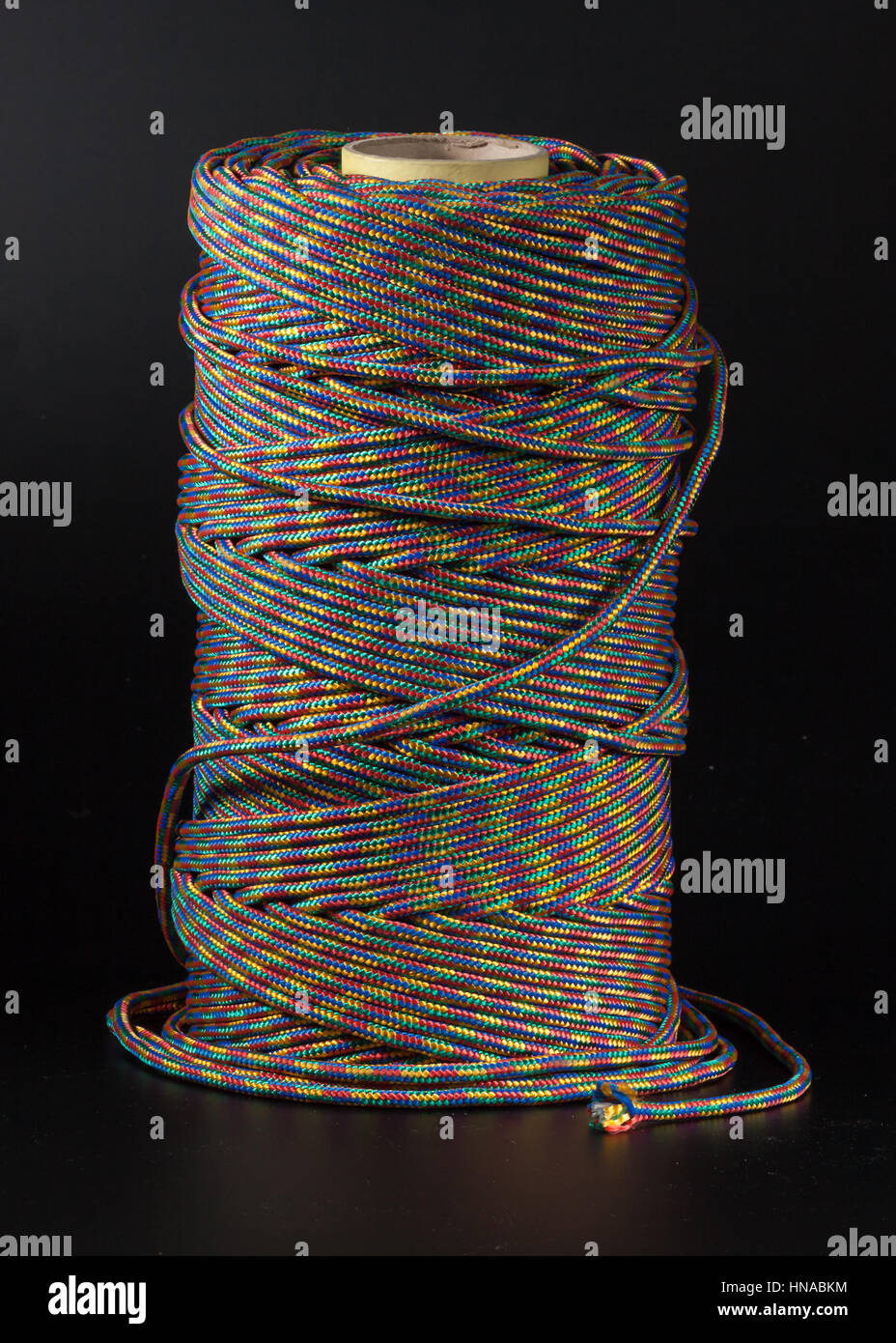 coil of rope on a black background colored rope Stock Photo