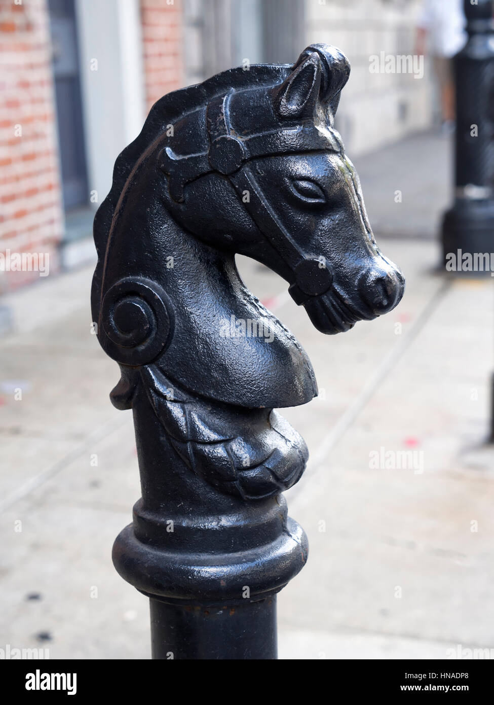 Horse head hitching posts line Royal Street in New Orleans Stock Photo
