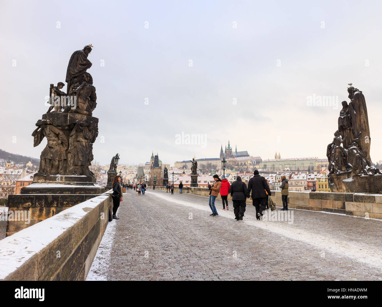 PRAGUE, CZECH REPUBLIC - JANUARY 16: Man taking photo of woman on Charles Bridge, Prague. In Prague, Czech Republic. On 16th January 2017. Stock Photo