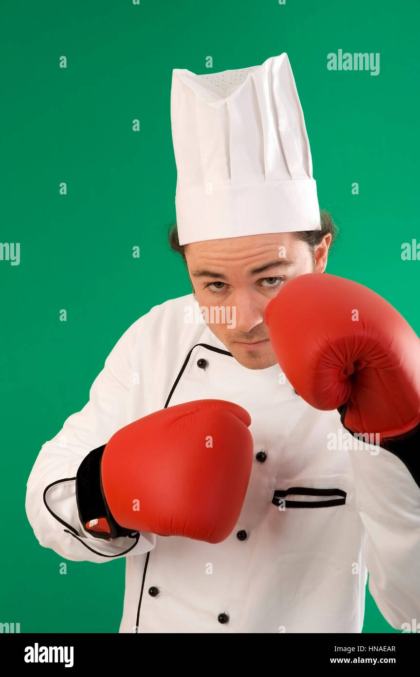 Koch mit Boxhandschuhen - cook with boxing gloves Stock Photo