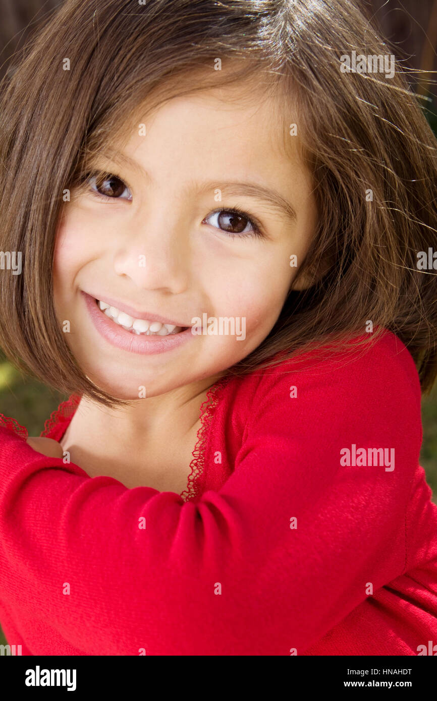 Portrait of a happy Hispanic little girl smiling. Stock Photo
