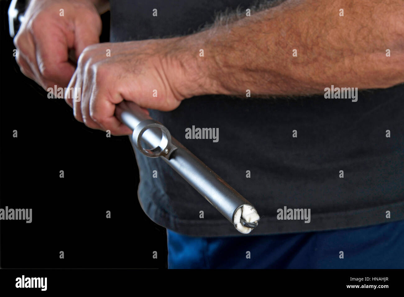 Gunsmith pushing swabs through the barrel of a 20 gauge pump action