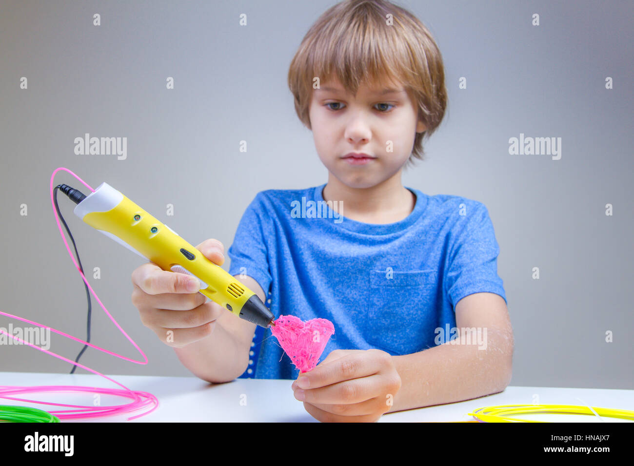 Child using 3D printing pen. Boy making heart. Creative, leisure ...