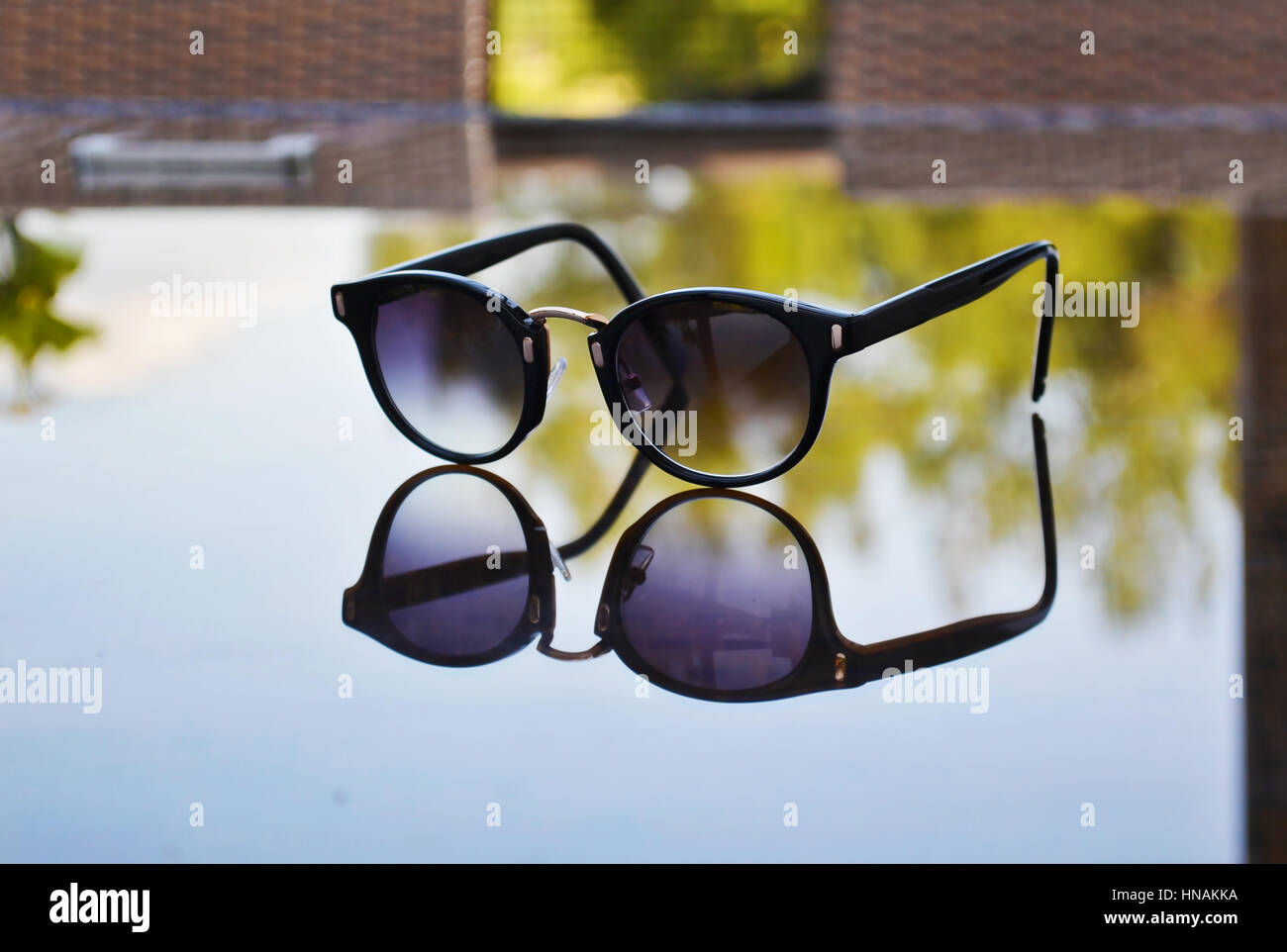 sunglasses reflection on table Stock Photo Alamy