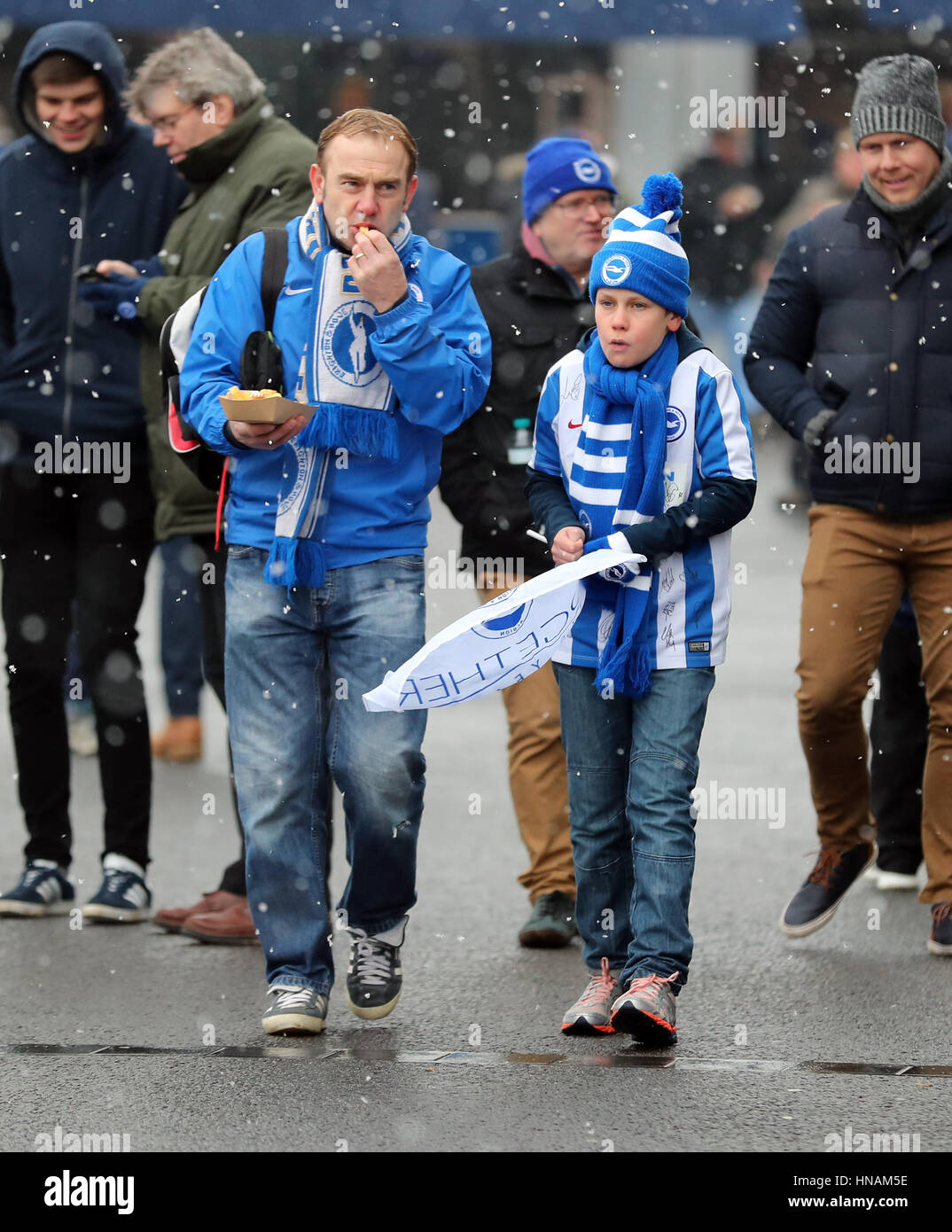 Brighton fans arrive in the cold weather before the Sky Bet Championship match at the AMEX Stadium, Brighton. PRESS ASSOCIATION Photo. Picture date: Saturday February 11, 2017. See PA story SOCCER Brighton. Photo credit should read: Gareth Fuller/PA Wire. RESTRICTIONS: No use with unauthorised audio, video, data, fixture lists, club/league logos or 'live' services. Online in-match use limited to 75 images, no video emulation. No use in betting, games or single club/league/player publications. Stock Photo