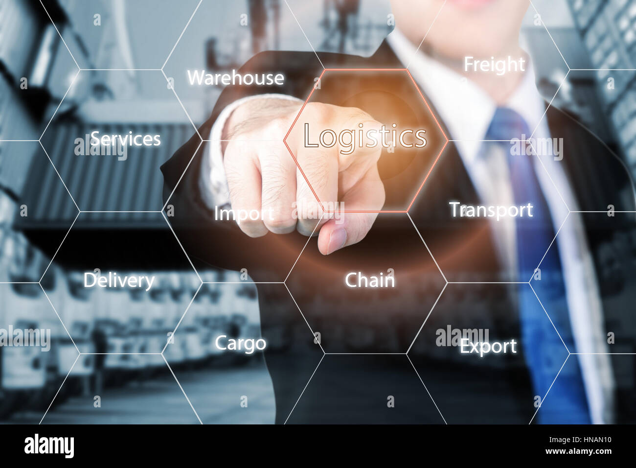 Logistics concept with businessman hand holding digital tablet shipping icons use for import, export and logistics background. Stock Photo