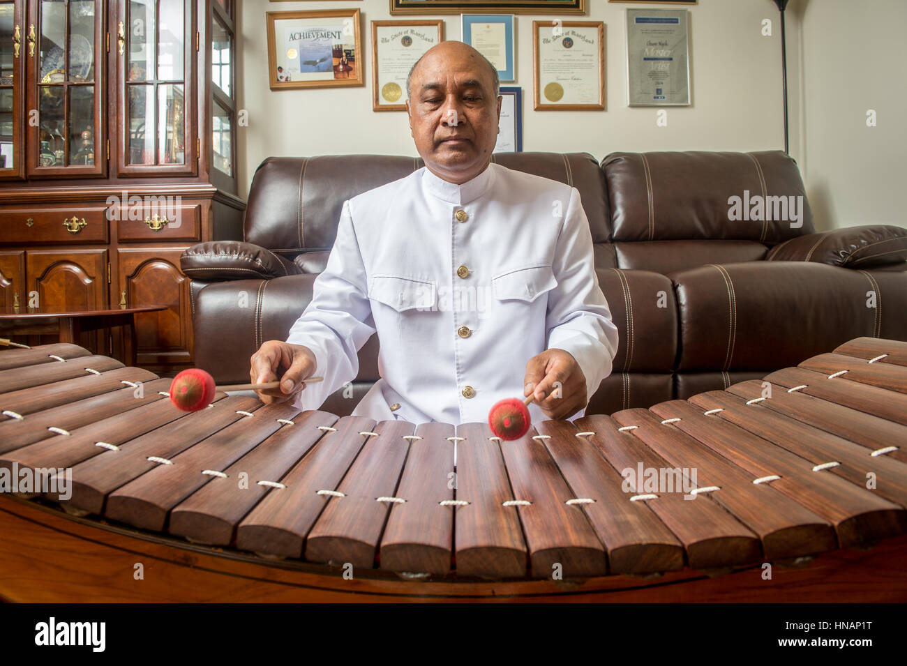 Chum Ngek, a Cambodian artist, plays the xylophone in his home Stock