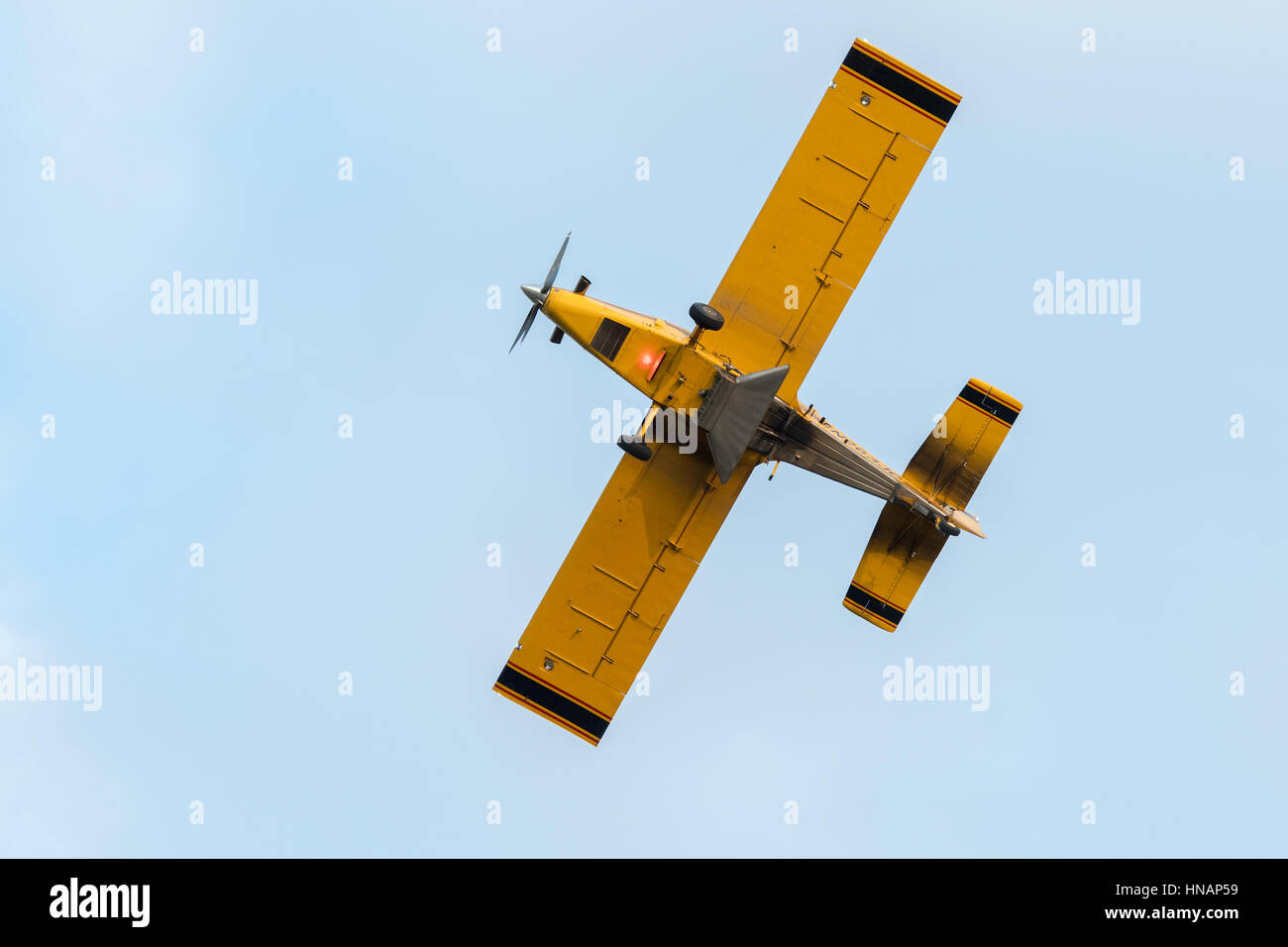 A crop-duster plane flies over a farm and coats crops with pesticides in Secretary, Maryland. Stock Photo
