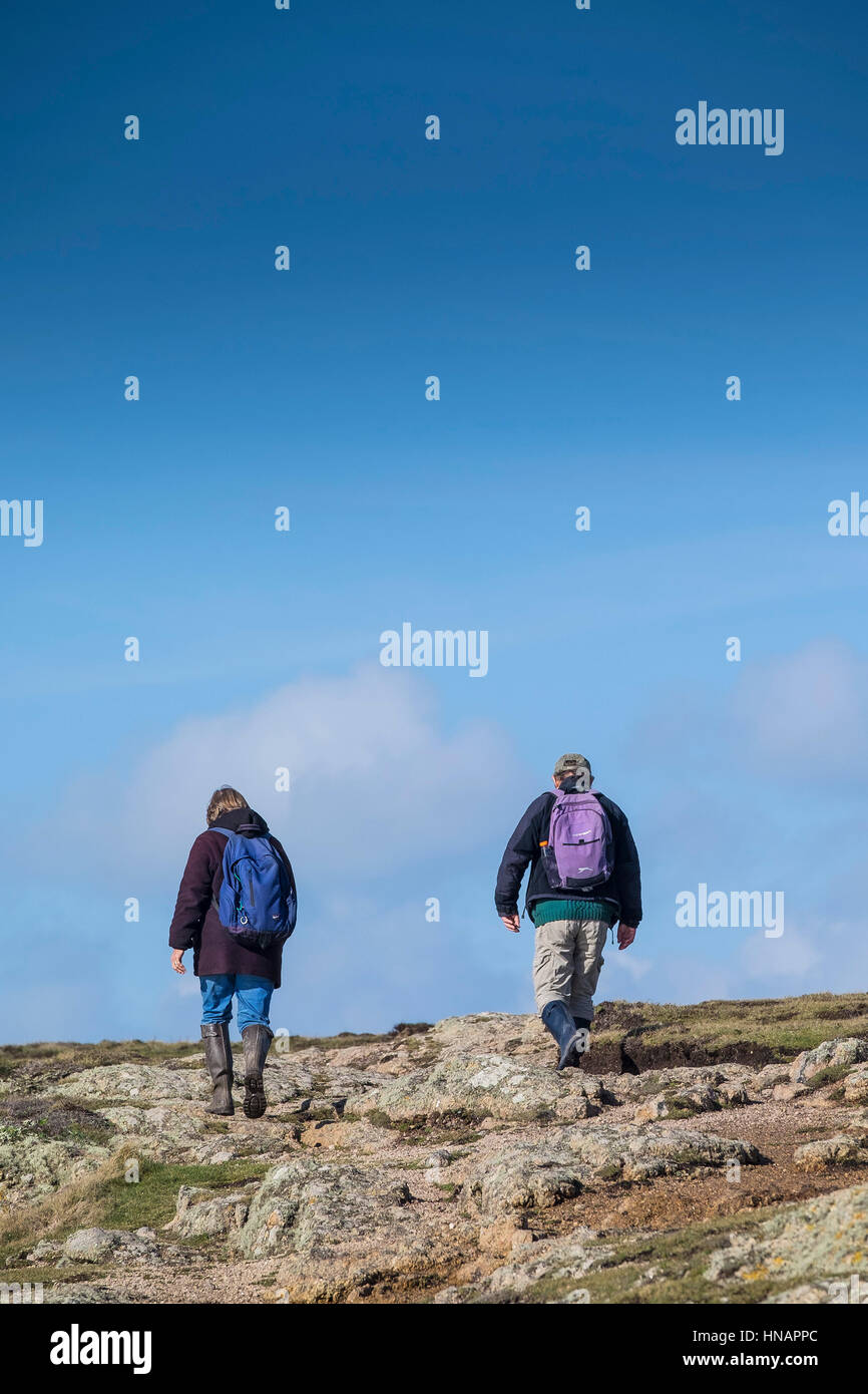 Two walkers on the South West Coastal Path on Gwennap Head in Cornwall, England. Stock Photo