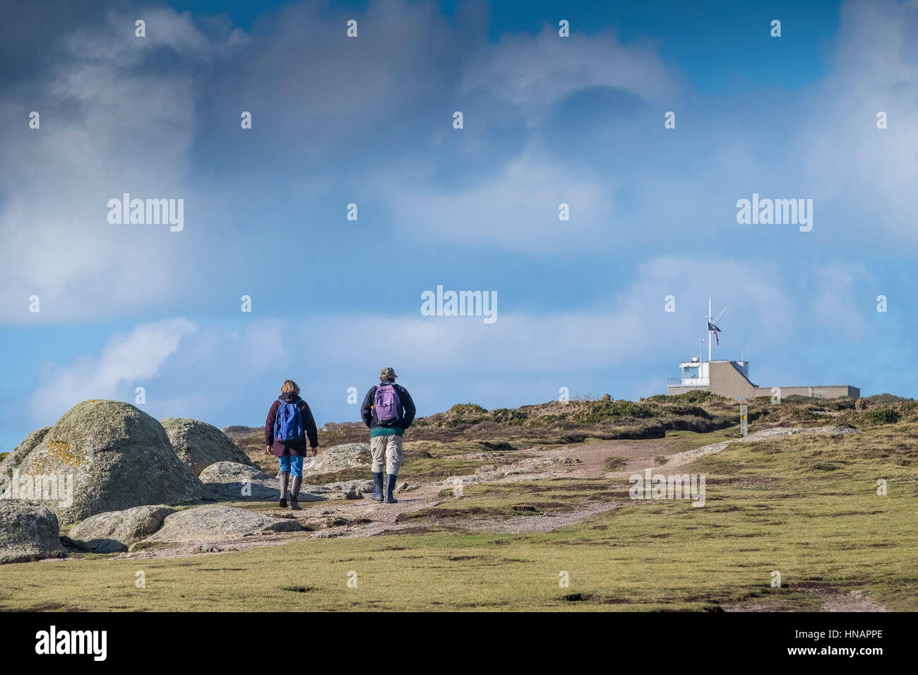 Two walkers on the South West Coastal Path on Gwennap Head in Cornwall, England, UK. Stock Photo