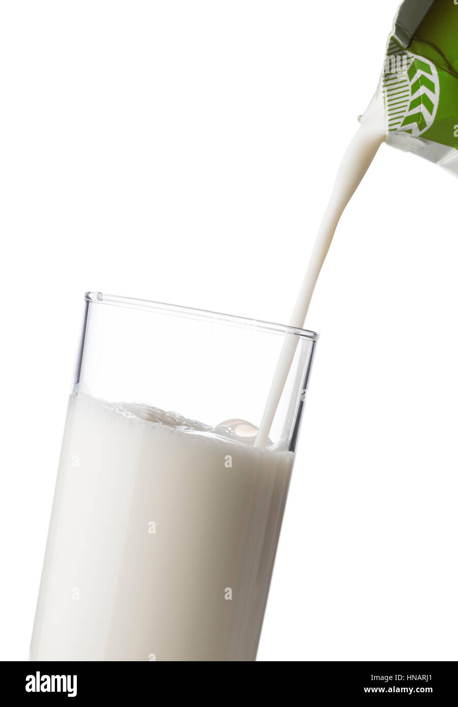 pouring milk into a glass from milk carton, on white background Stock Photo