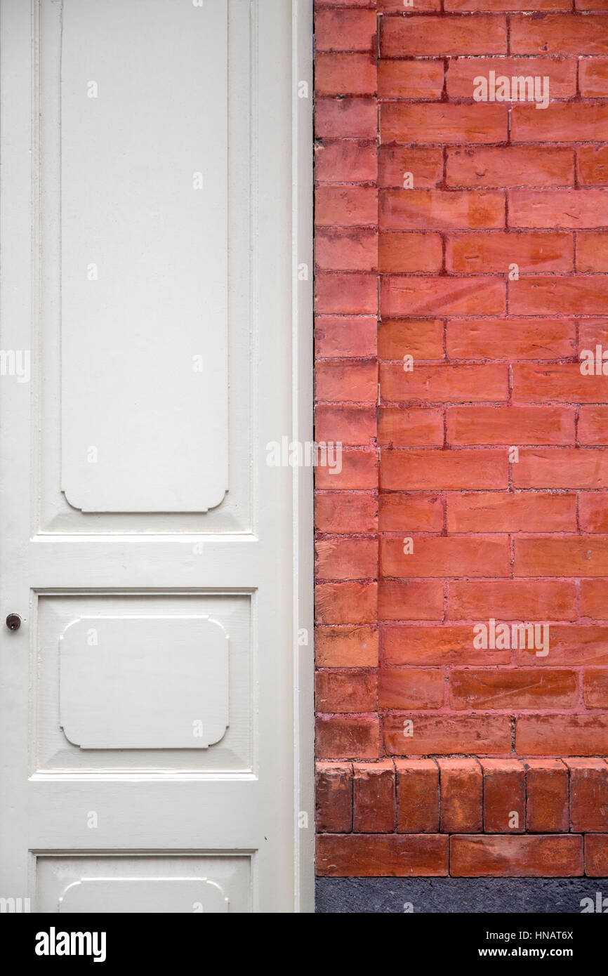 White entrance door with the brickwall facade Stock Photo
