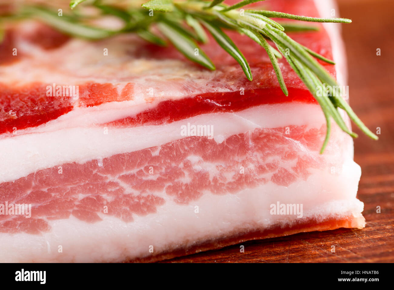 italian bacon pancetta on wooden chopping board italian food Stock