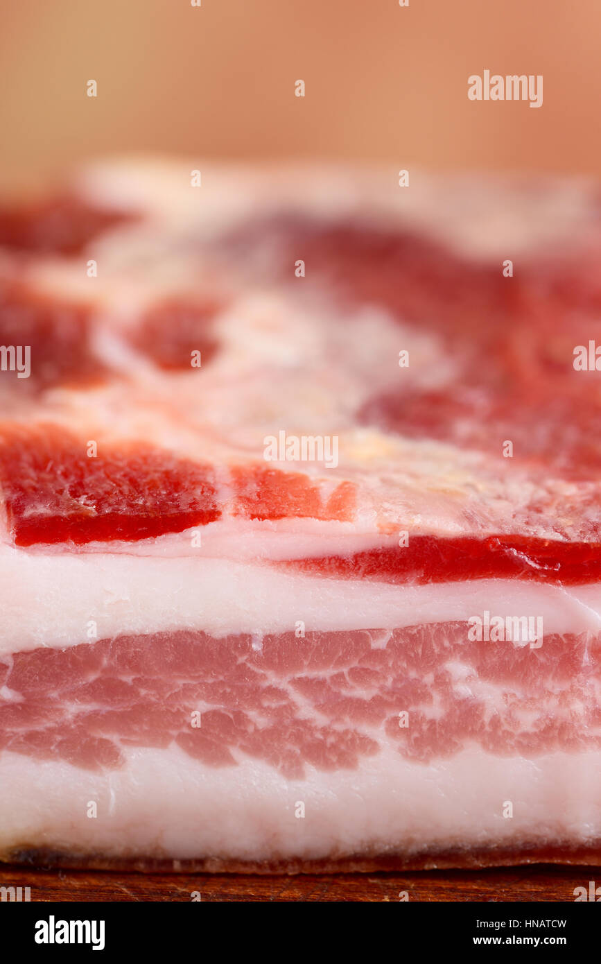italian bacon pancetta on wooden chopping board italian food Stock
