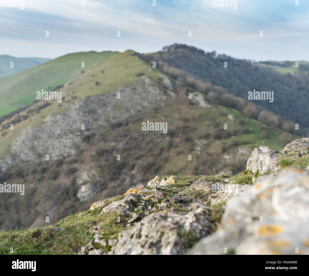 The summit of Thorpe Cloud in sharp focus in the foreground, Peak District, Derbyshire. Stock Photo