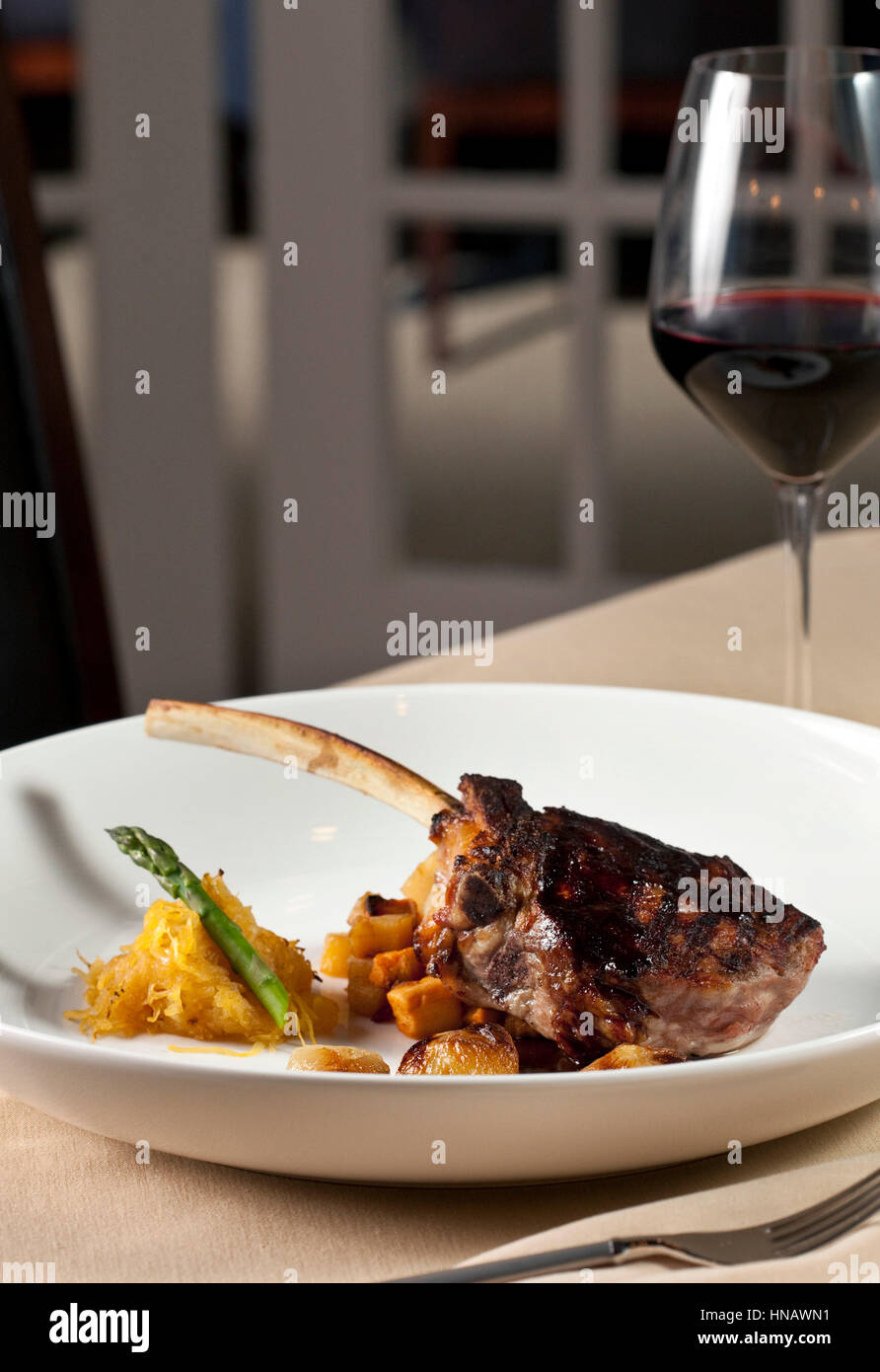 Bone in rib eye steak with red wine on white plate, David's Restaurant