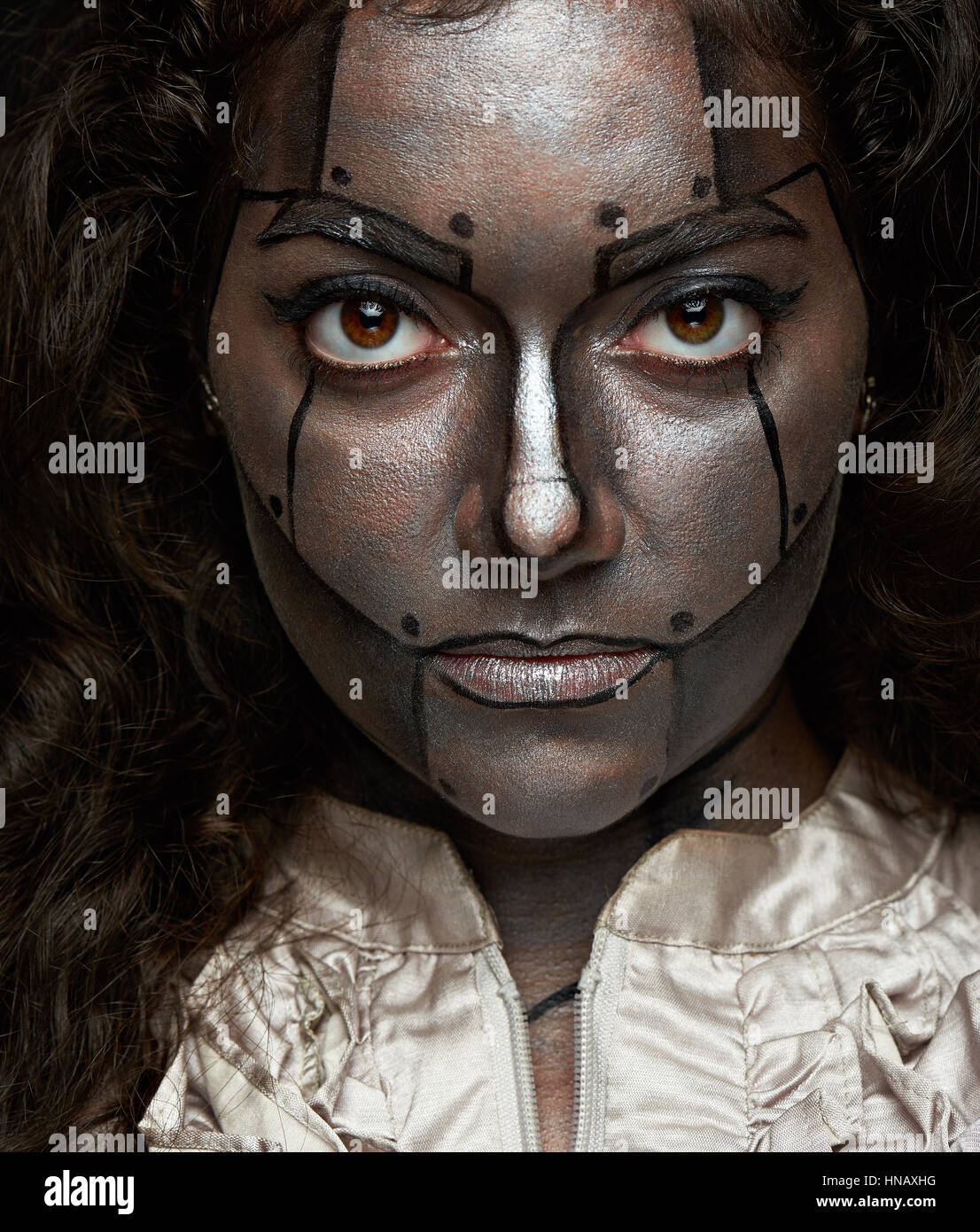 close up of women face with metal robot body art Stock Photo