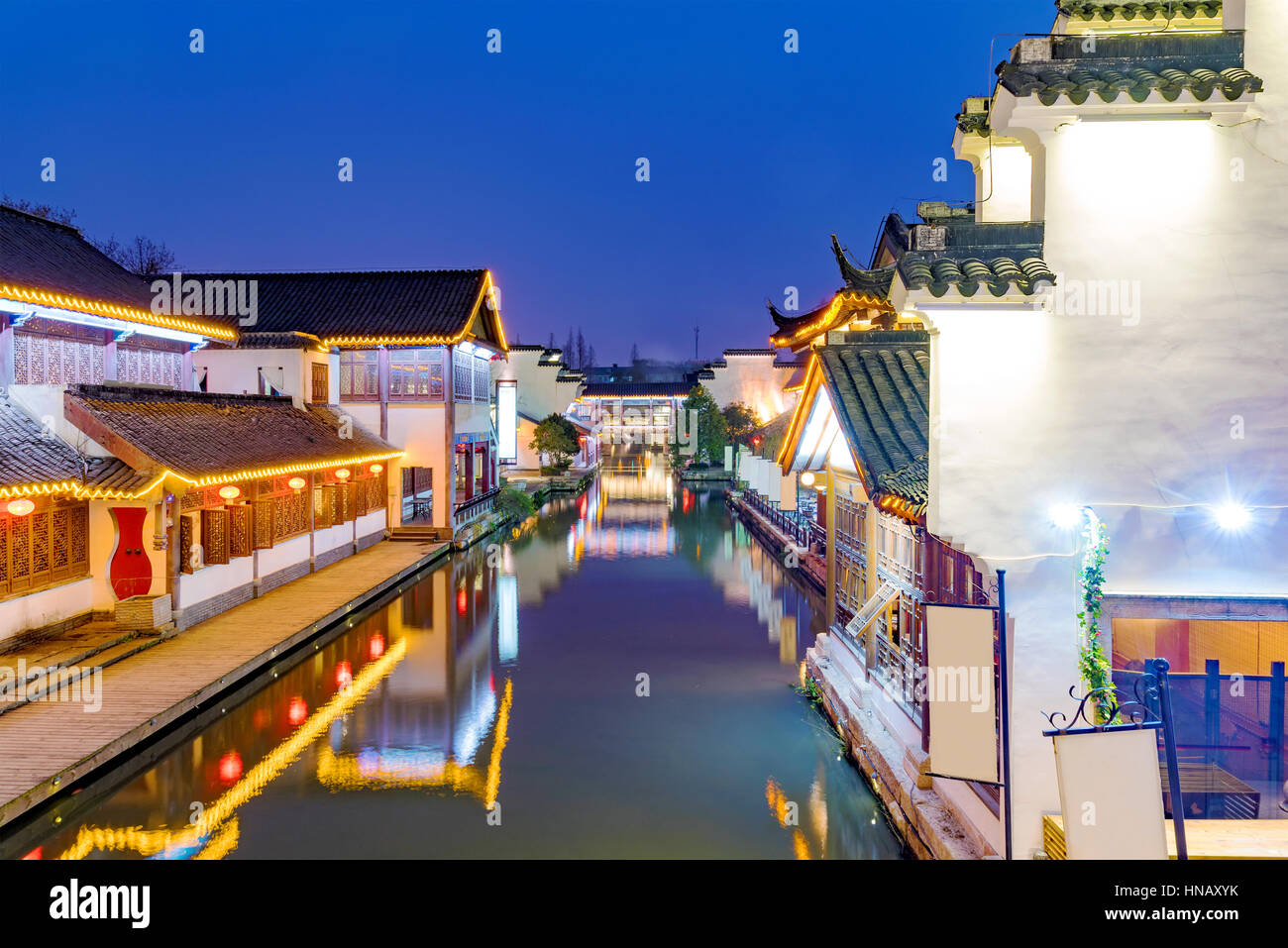 traditional Chinese architecture on a river at night in Nanjing Stock Photo