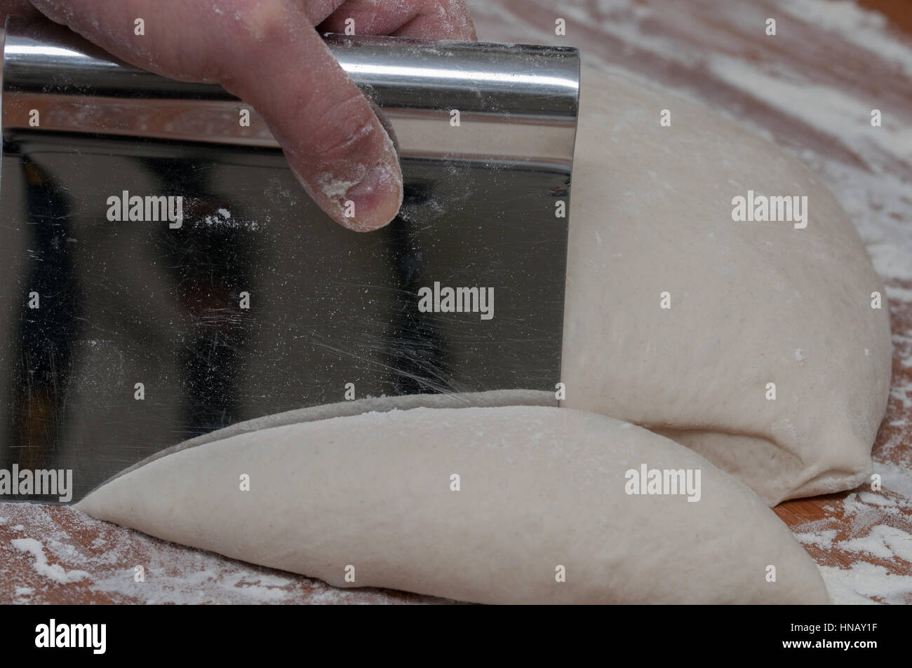dough cutting with a steel kitchen utensil, close up Stock Photo Alamy