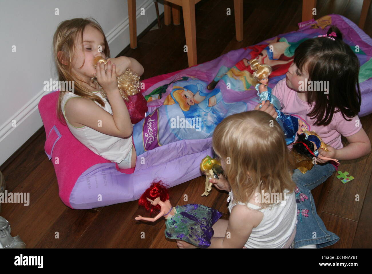 Blonde Children girls kids playing with barbie dolls, childhood memories, children toys Stock Photo