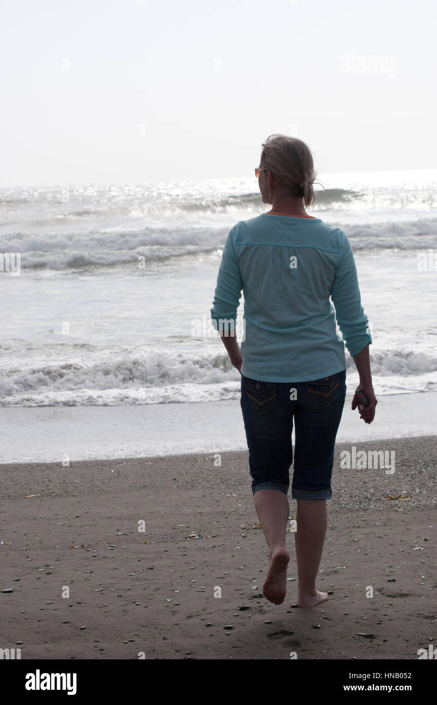 Woman walking barefoot park hi-res stock photography and images - Alamy