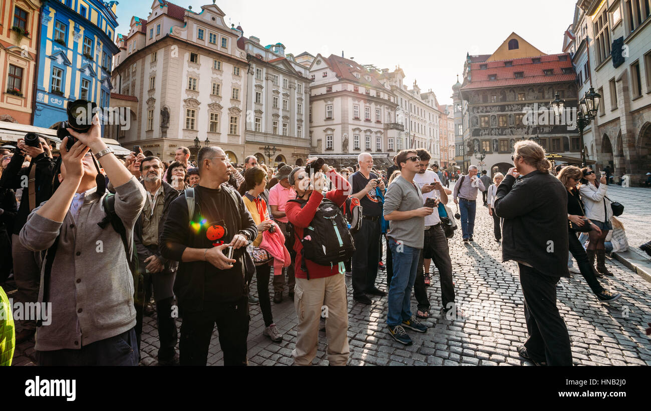 Prague, Czech Republic - October 13, 2014: Group of tourists taking photo of town hall with astronomical clock - Orloj Stock Photo
