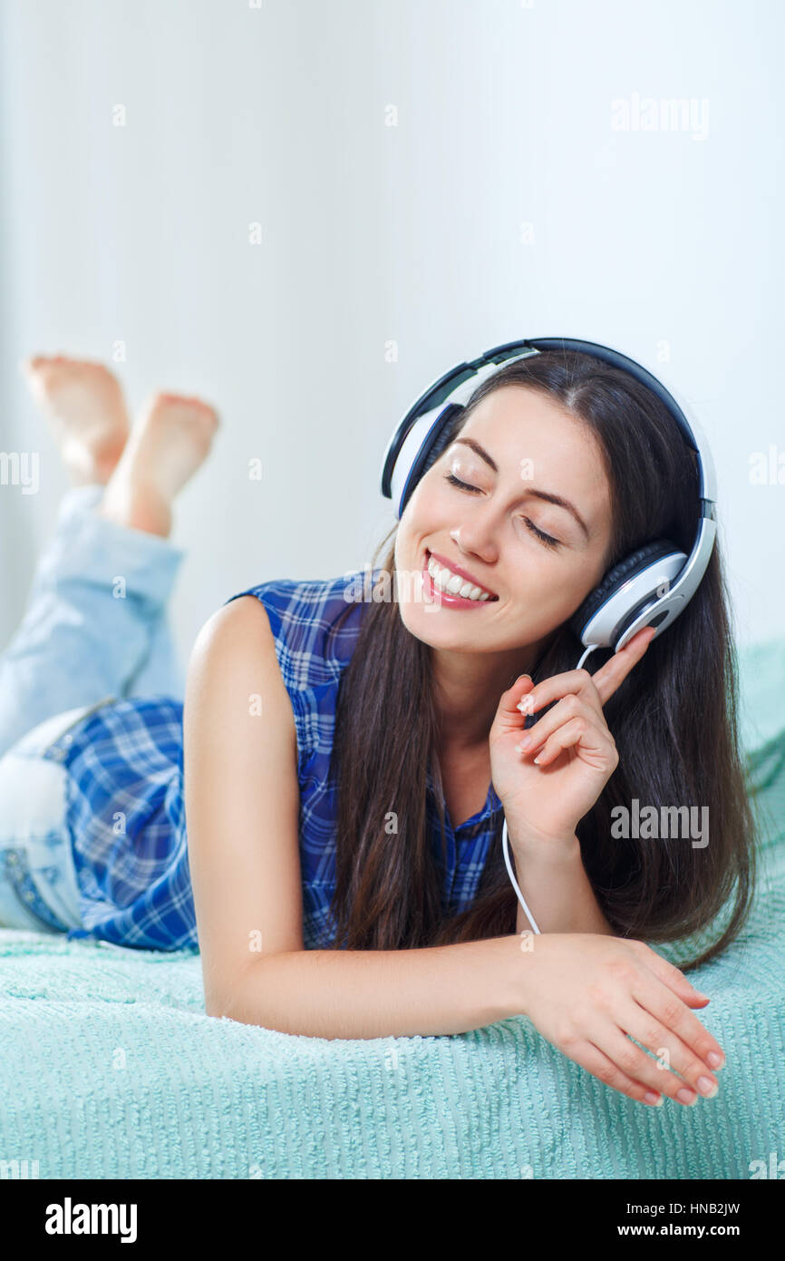 girl listening to music in headphones at home Stock Photo