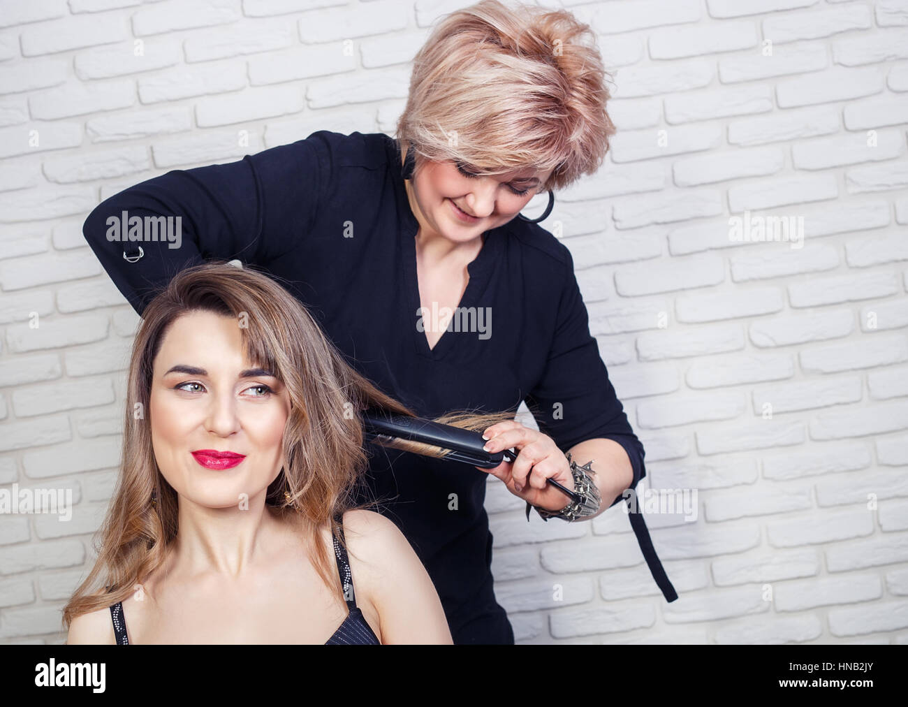 hairdresser curling hair Stock Photo