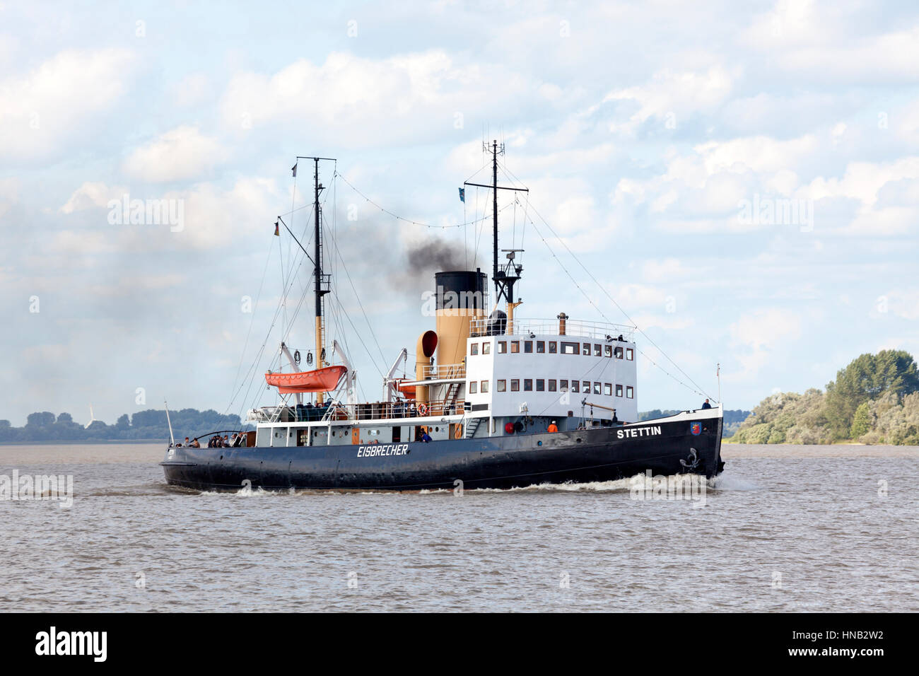 Stade, Germany - August 21, 2016: Historic icebreaker STETTIN on the Elbe river. Today the steam ship, built in 1933, is used for touristic excursions Stock Photo