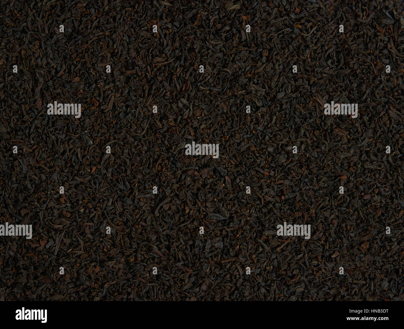 Heap of black tea scattered on the surface for the background Stock Photo