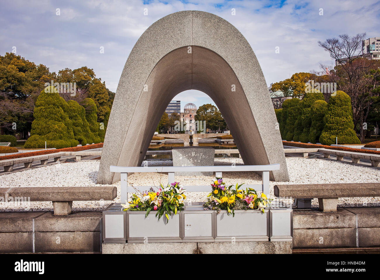 Cenotaph for the Atomic bomb victims, in background Atomic Bomb Dome, Peace Park, Hiroshima, Japan Stock Photo