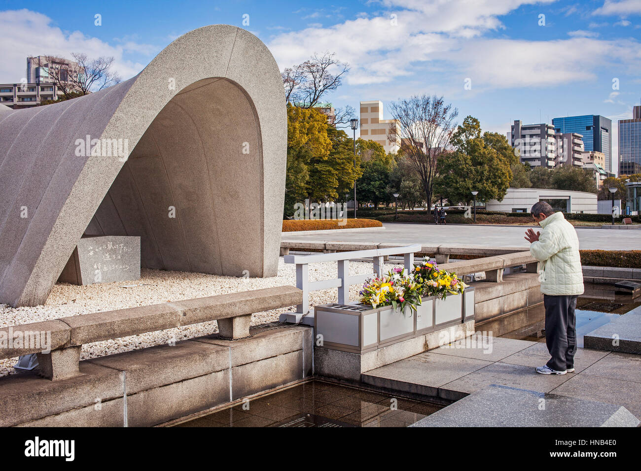Praying, Cenotaph for the Atomic bomb victims, Peace Park, Hiroshima, Japan Stock Photo