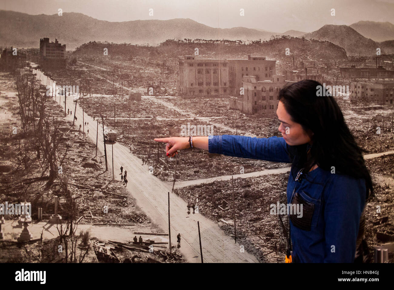 visitor looks a photo of Hiroshima after the atomic bomb explosion, Hiroshima Peace Memorial Museum, Hiroshima, Japan Stock Photo