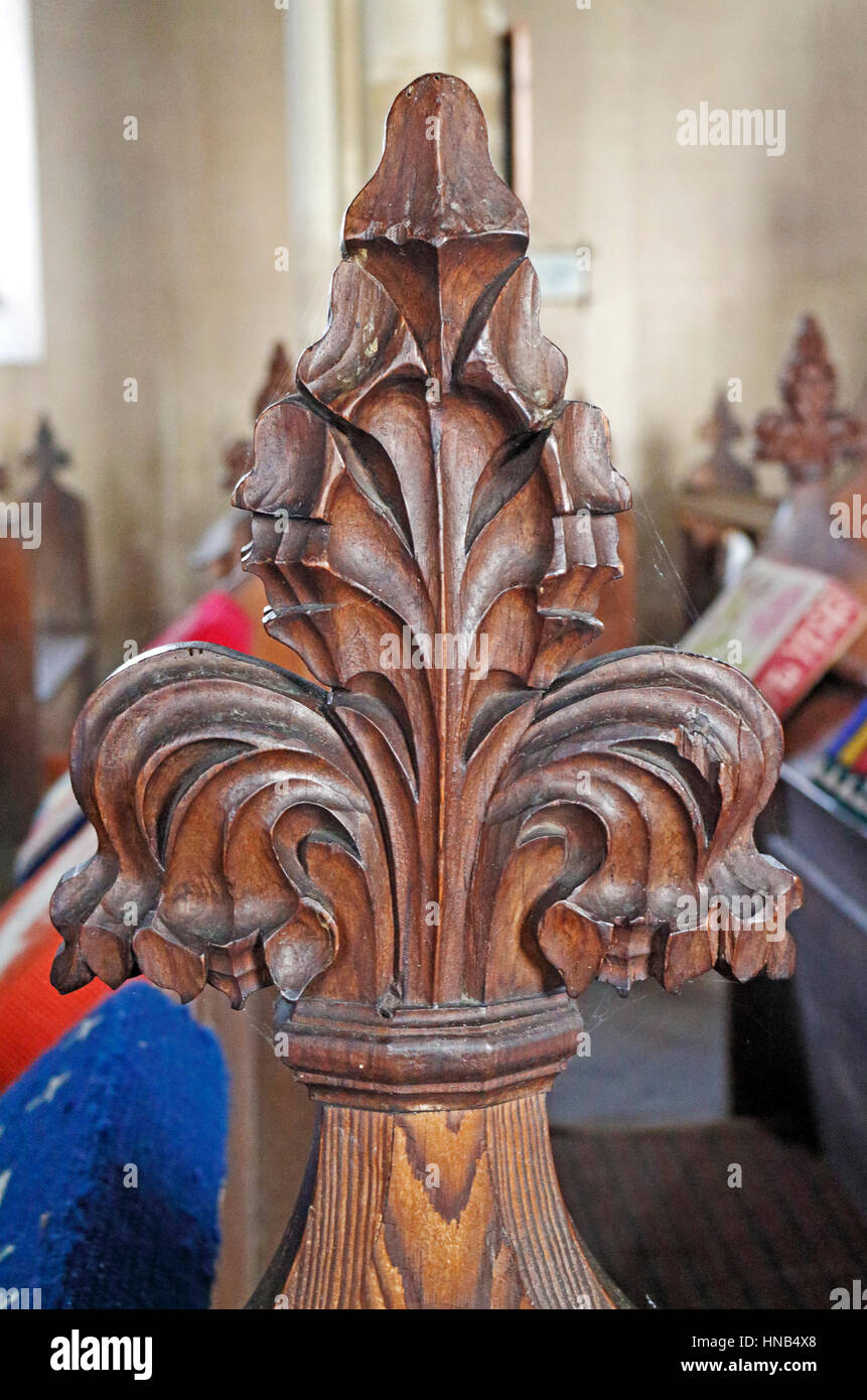 A view of a poppy head bench end in the parish church of St Peter at Billingford, Norfolk, England, United Kingdom. Stock Photo
