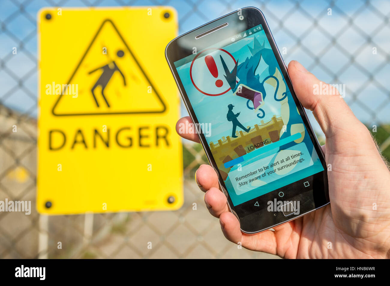 Montreal, CA - July 27, 2016: Closeup of the loading screen of the  videogame Pokemon Go remembering players to be alert. Pokemon Go is a  virtual reali Stock Photo - Alamy