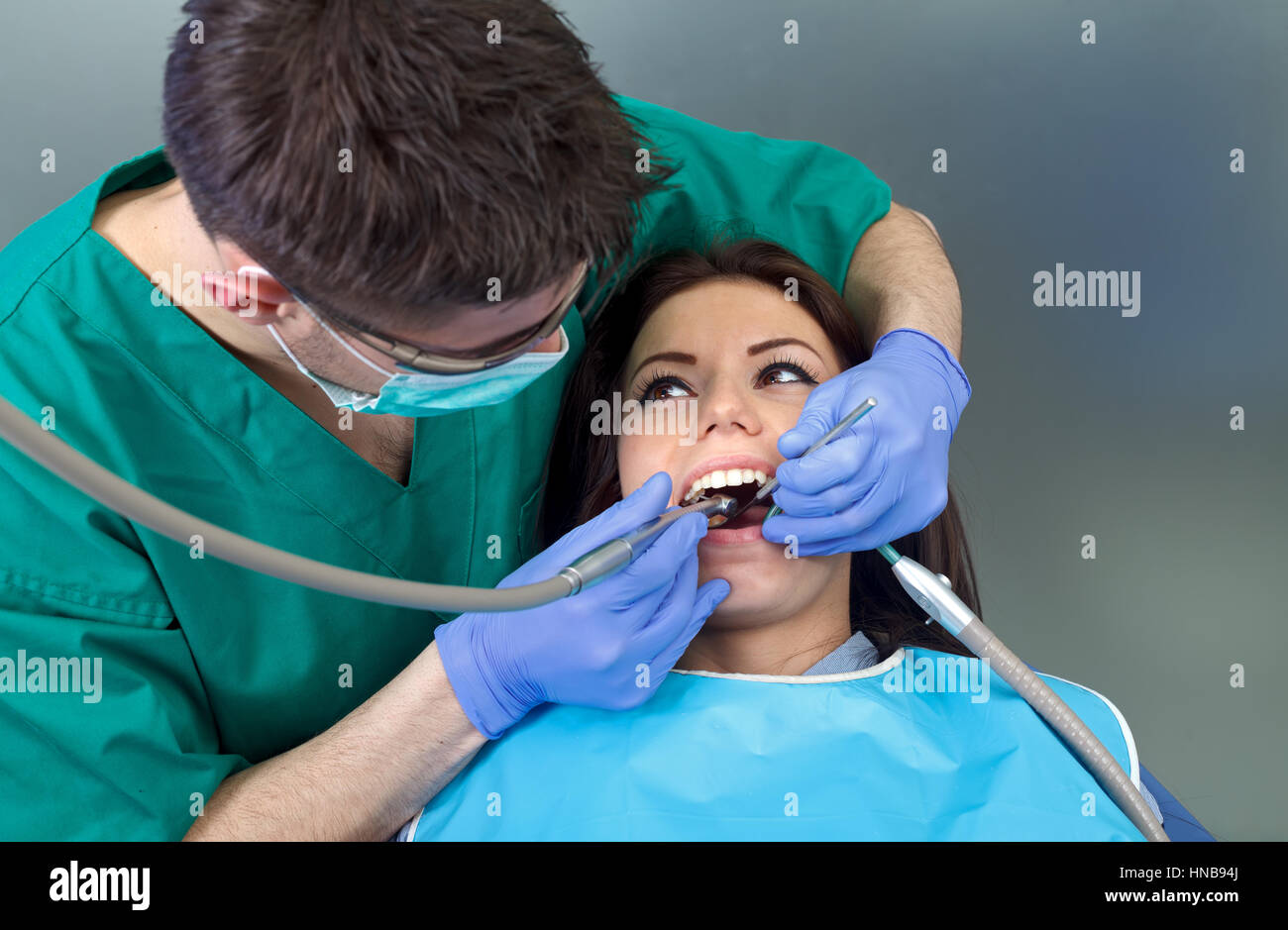 The confident dentist drilling the patient's teeth Stock Photo Alamy