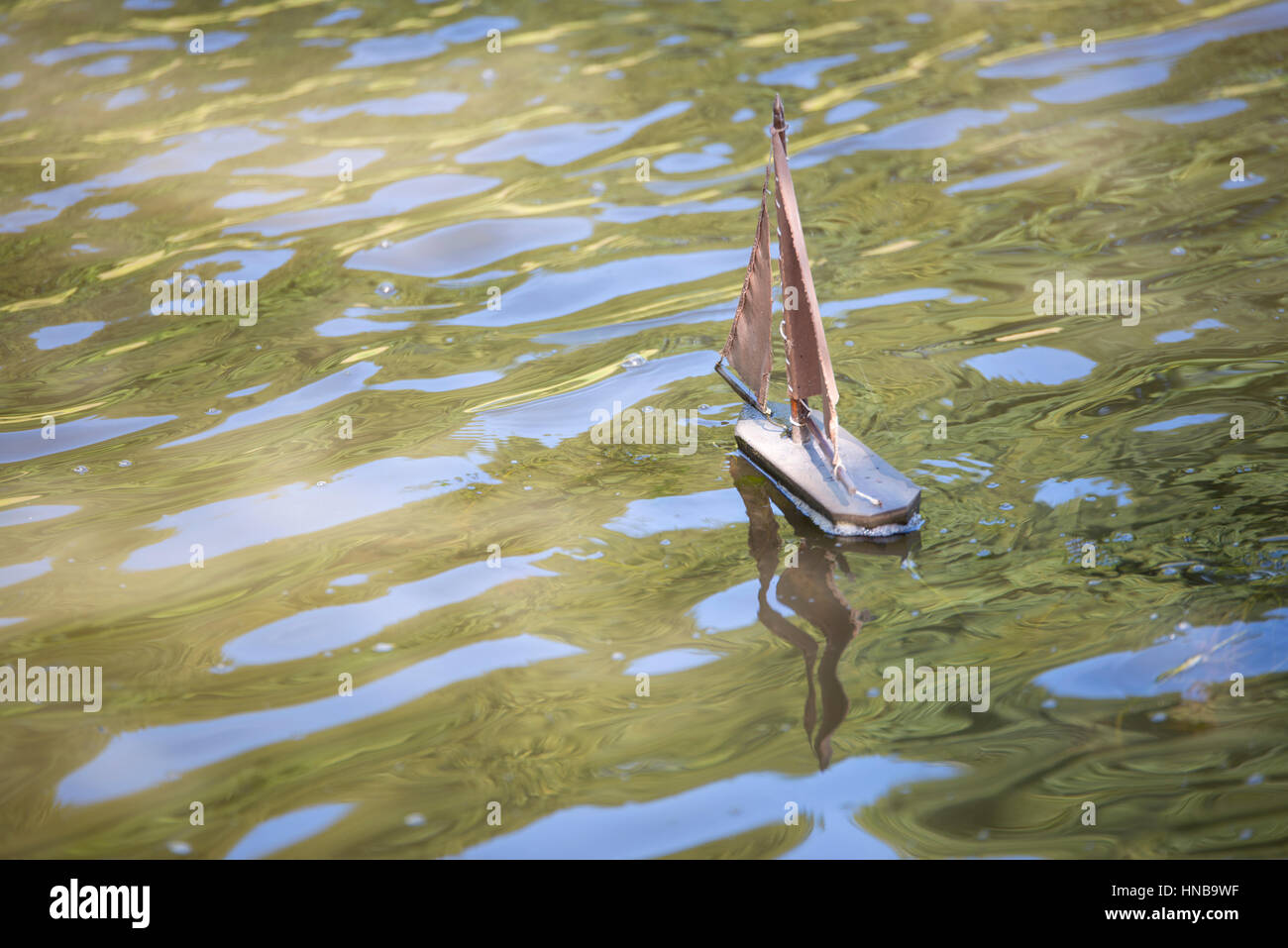 floating wooden boat toy floating on the water Stock Photo - Alamy