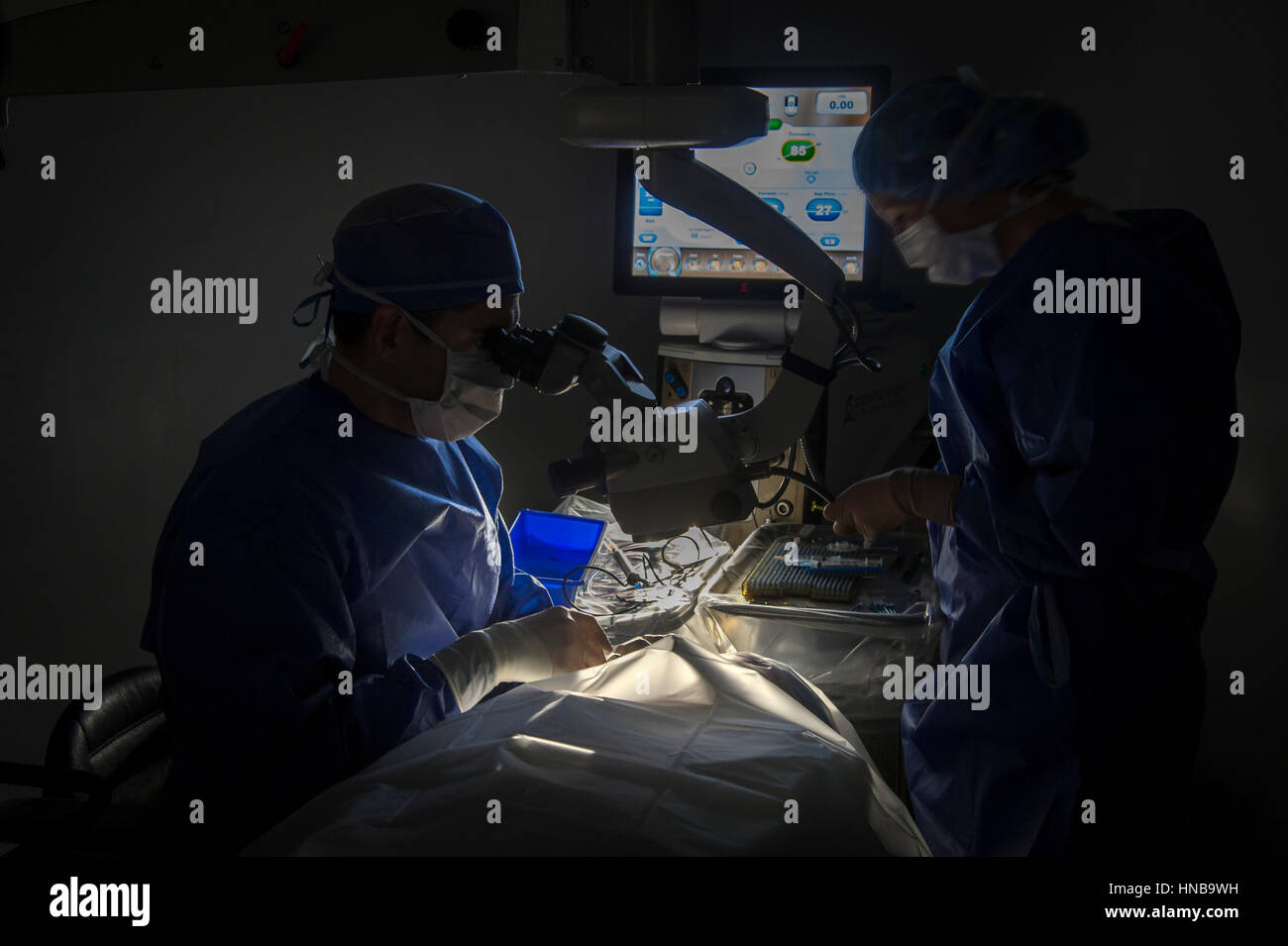 Surgeon Performing Eye Surgery Stock Photo