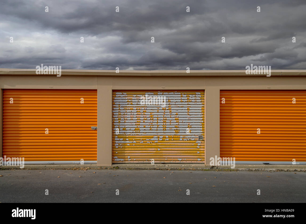 Orange Self Storage Units With Approaching Storm Stock Photo