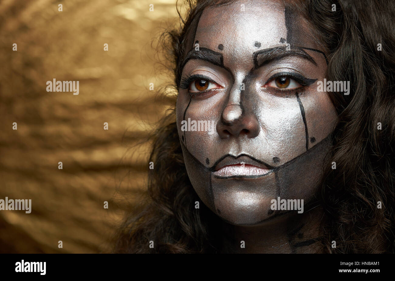 clode up of cyborg women face on golden background Stock Photo - Alamy