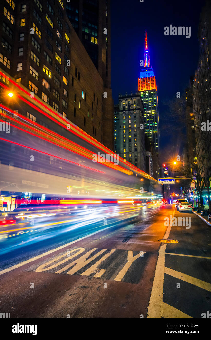 New York traffic in the night and Empire State Building on the back. Stock Photo