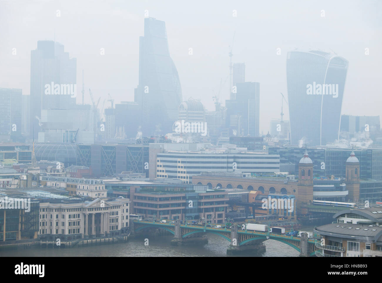 View of cityscape and air pollution over The City of London financial district skyscrapers buildings on 24 January 2017 in London UK   KATHY DEWITT Stock Photo