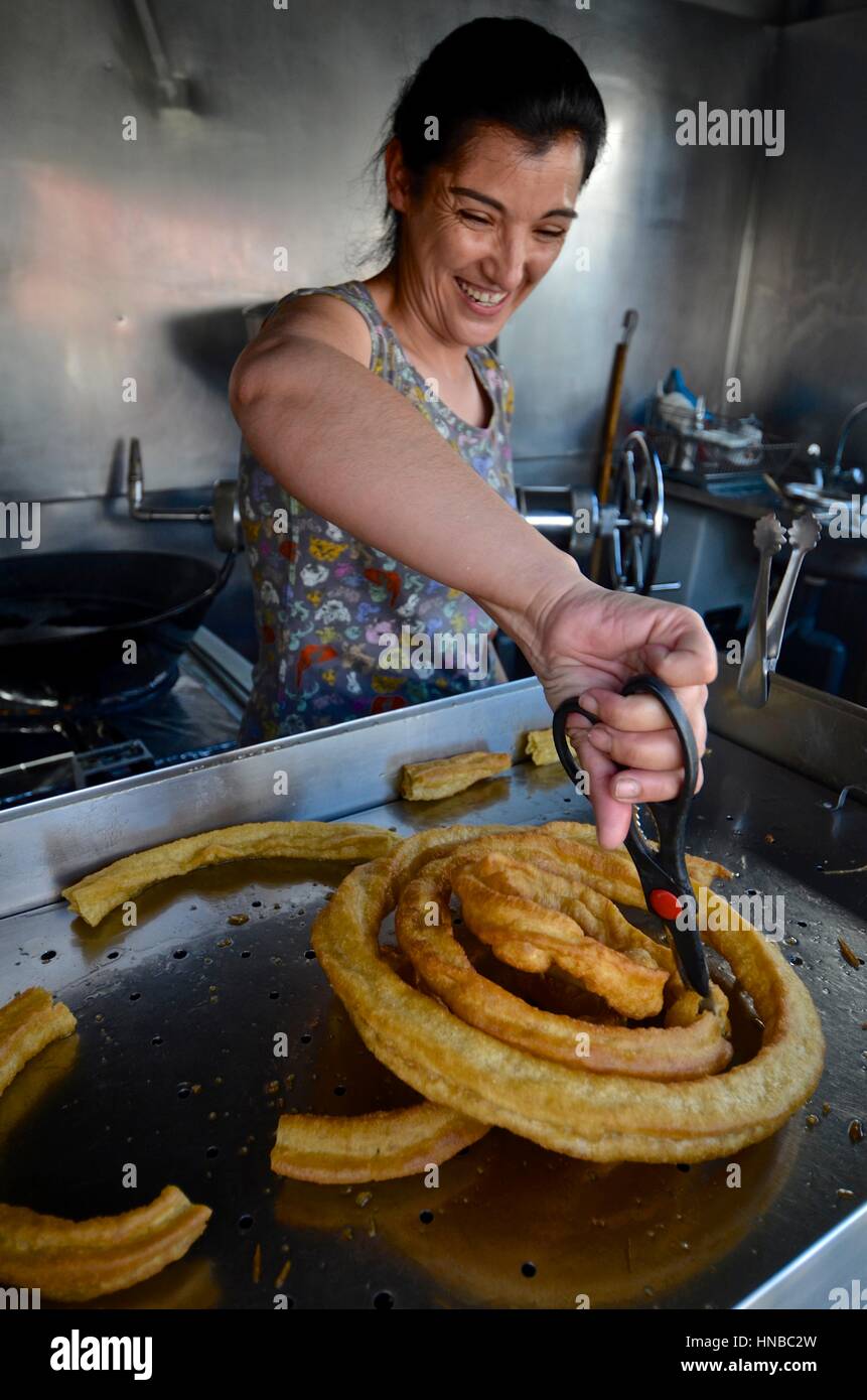 Preparing traditional Spanish churros, a frieddough pastry Stock Photo