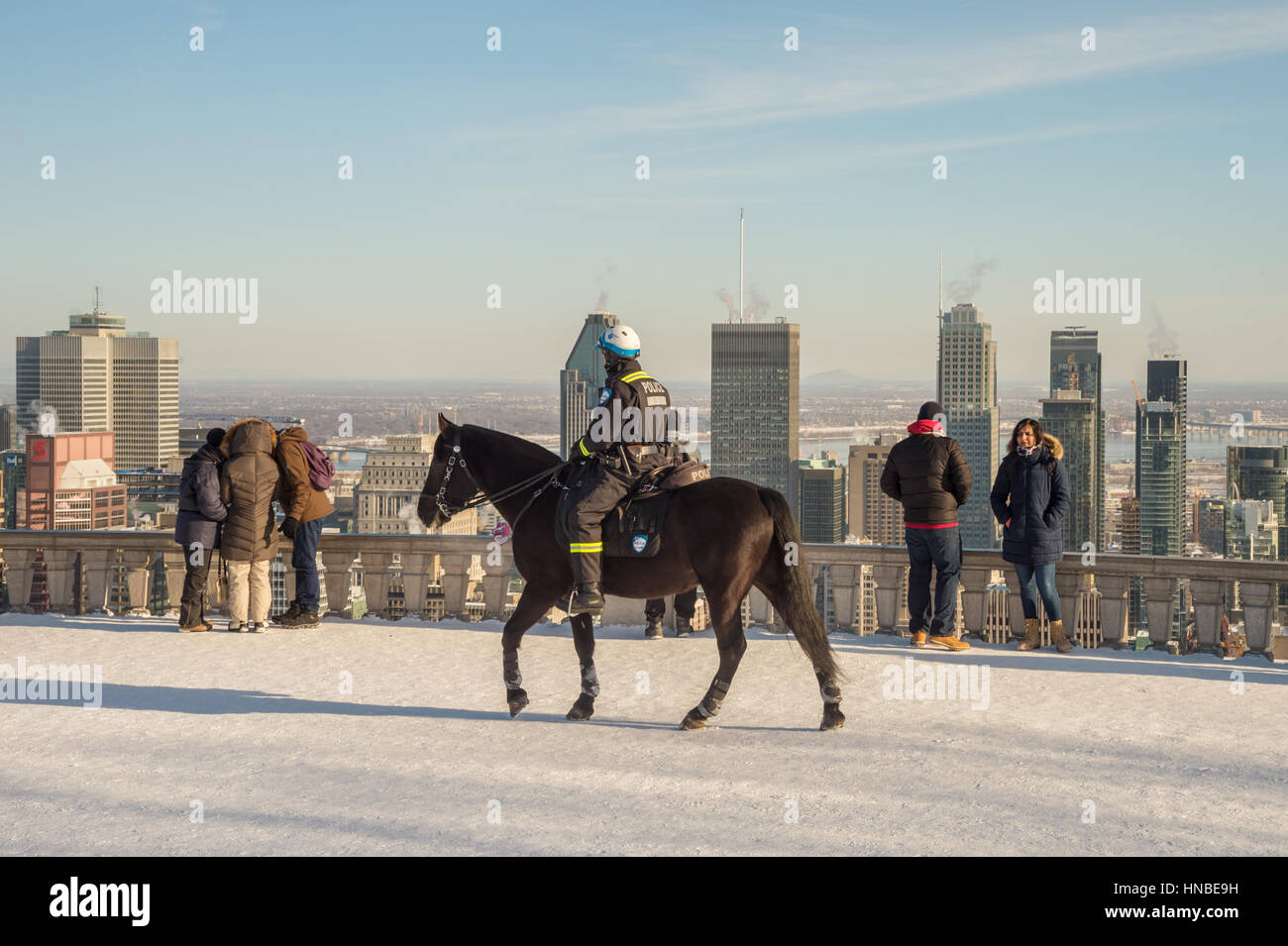 Montreal, CA - 10 February 2017: RCMP Mounted police officer patroling on Kondiaronk Belvedere on Mount-Royal Stock Photo