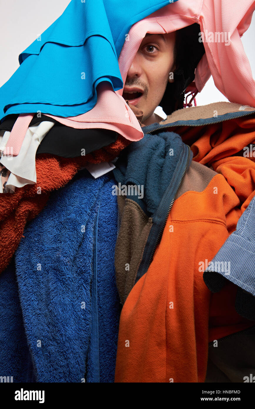 man looking from his messy colourful clothing Stock Photo